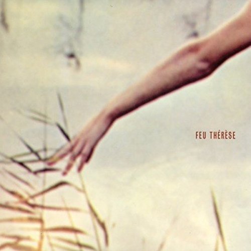 Hand reaching towards blades of grass, album cover for Feu Thérèse.