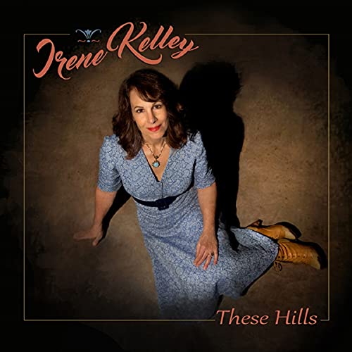 Irene Kelley album cover, portrait of a woman with boots, titled "These Hills".