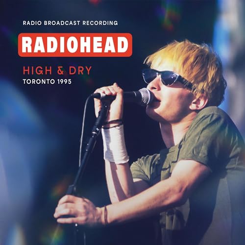 Radiohead’s Thom Yorke singing into a microphone on a concert stage.
