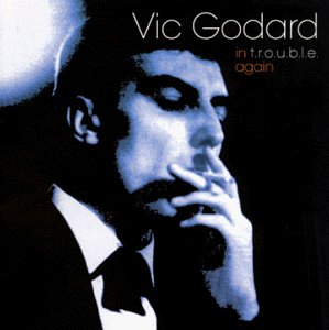 Blue-toned portrait of Vic Godard smoking, album cover for “In Trouble Again.”
