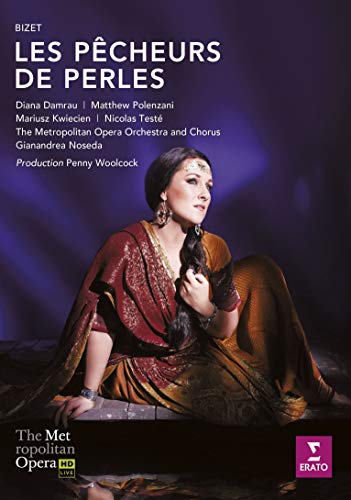 Diana Damrau in a red and gold costume against a dark purple background.