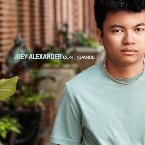 Joey Alexander album cover featuring a young man’s portrait.