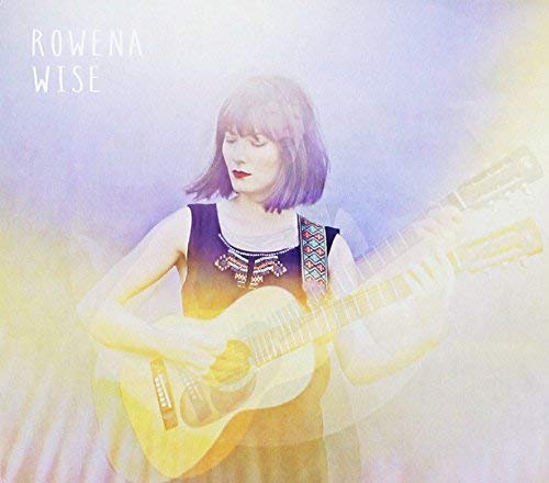 CD cover featuring a woman with a guitar, soft lighting.