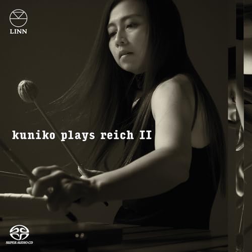 Close-up of Kuniko, a percussionist, holding mallets, album cover art.