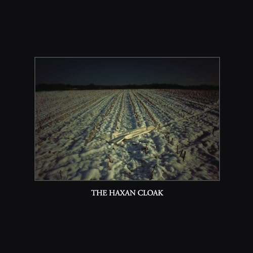 Snowy field with a crashed airplane, album cover for The Haxan Cloak.