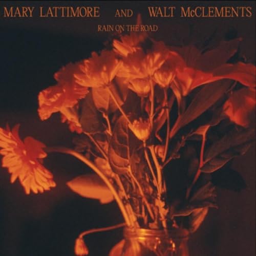 CD cover: orange and red flowers in a glass jar, dark background.