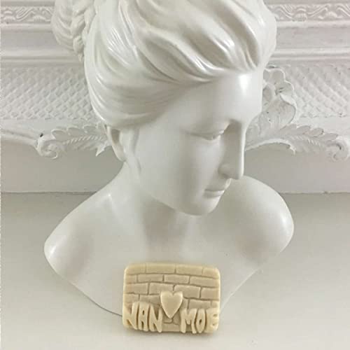 Vinyl record with brick-patterned cover resting on a white bust.