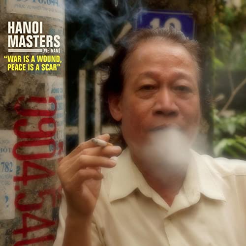 CD cover: Man smoking with posters in a blurred background.