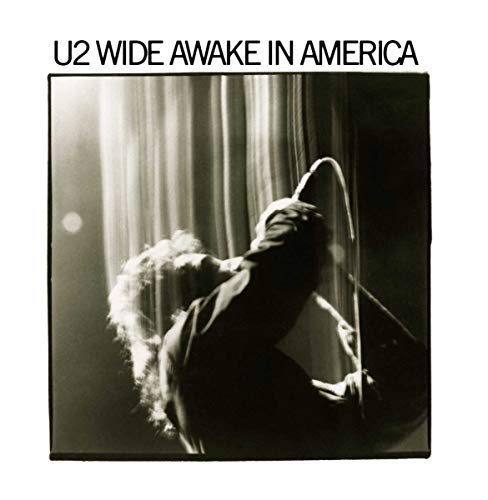 Black and white album cover featuring a musician bending backwards onstage.