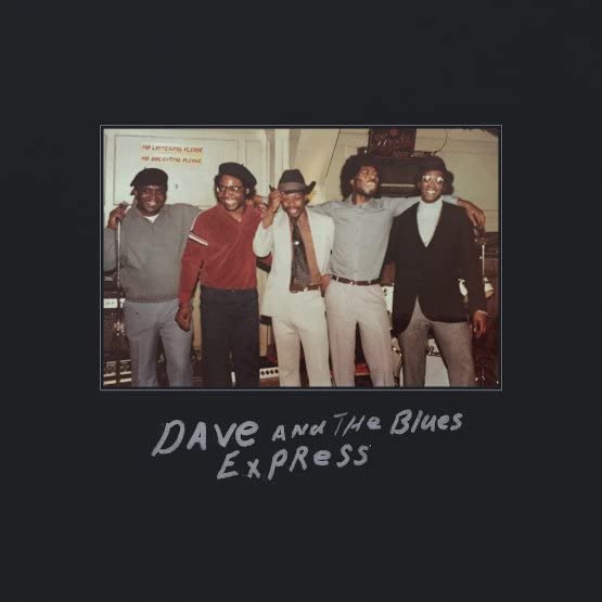 Four men standing in a room with the text Dave and the Blues Express below.