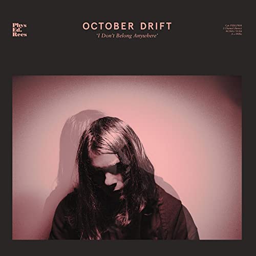 Album cover for October Drift's "I Don't Belong Anywhere," featuring a shadowed figure.