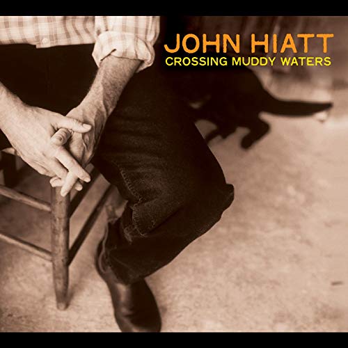 John Hiatt album cover: man on chair, boots in water.
