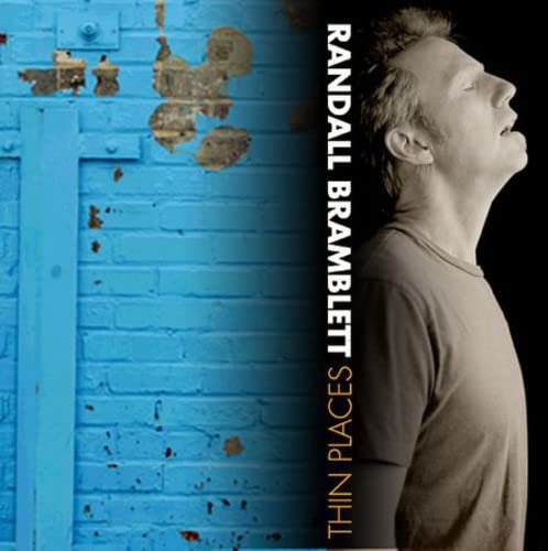 CD cover: Man’s profile against a textured blue brick wall.