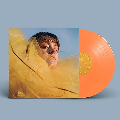 Vinyl record and album cover featuring a woman with yellow fabric.