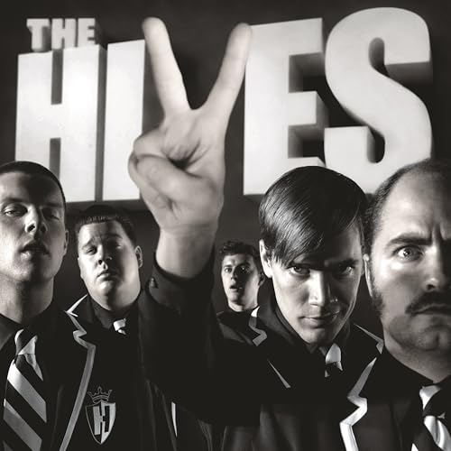 Black and white portrait of The Hives band members in suits.