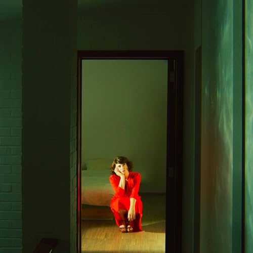 CD cover: woman in red suit sits in a doorway.