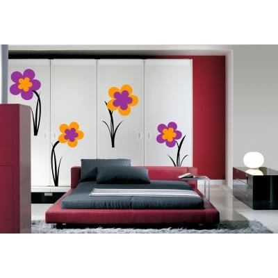Bedroom with a red bed and large floral decals on white wardrobe doors.