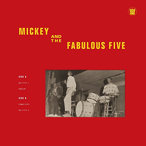 Red vinyl record cover featuring a band performing on stage.