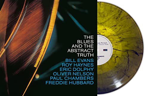 Vinyl record with marbled olive and black coloring, album artwork visible.
