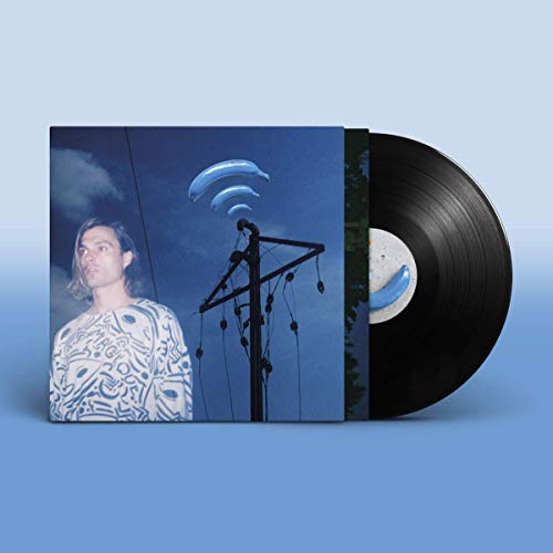 Vinyl record and album cover featuring a man and blue whale shapes.