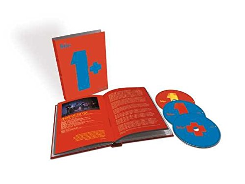 The Beatles 1+ box set with an open book and two blue discs.