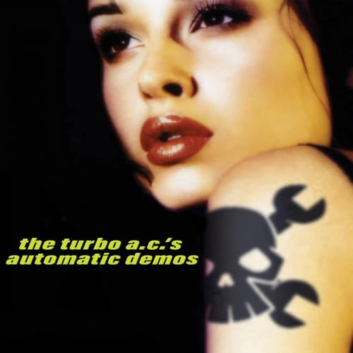Close-up of a woman’s face with a wrench-shaped skull tattoo.