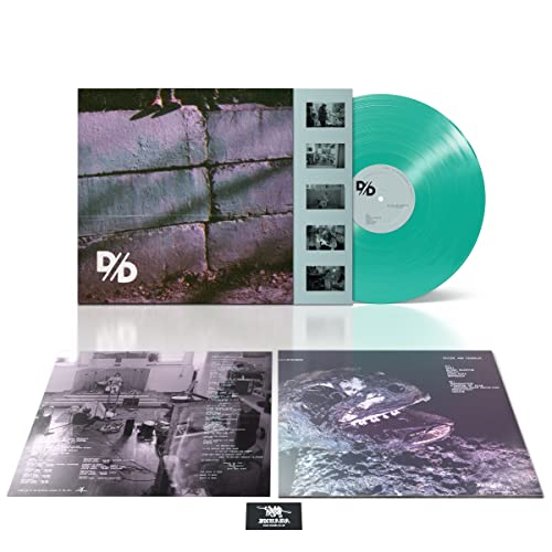 Vinyl record "Systemic" by Divide & Dissolve, with album artwork and inserts.