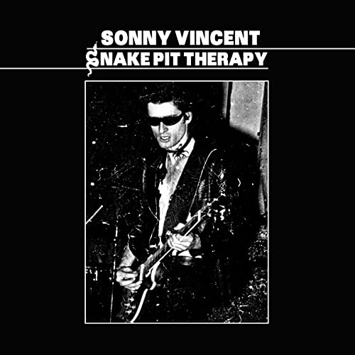 Black and white CD cover featuring a man with a guitar and sunglasses.