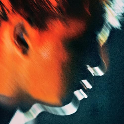 CD cover with blurred orange and black image of a face.