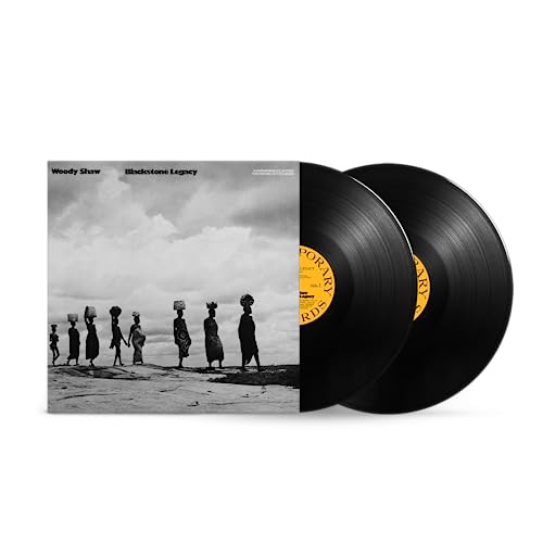Two black vinyl records with album cover depicting people walking.