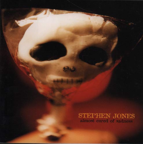 CD cover featuring a skull encased in red plastic, with text below.