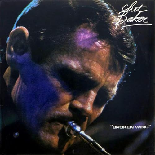Chet Baker portrait, playing trumpet, album cover with dark, moody tones.