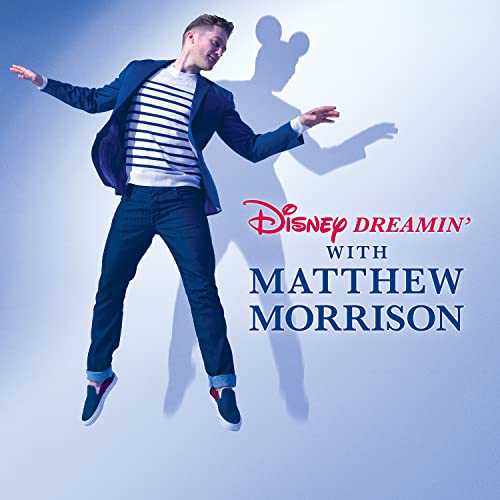 Matthew Morrison poses with a shadow of Mickey Mouse on a blue background.