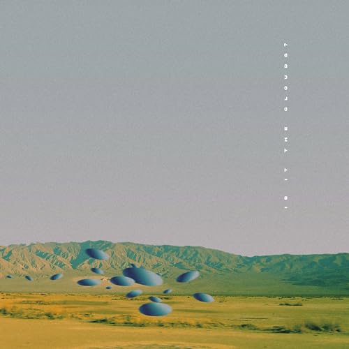 Album cover: blue shapes float over a landscape with hills.