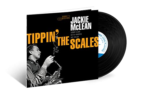 Black vinyl record with cover featuring a man playing saxophone and yellow text.