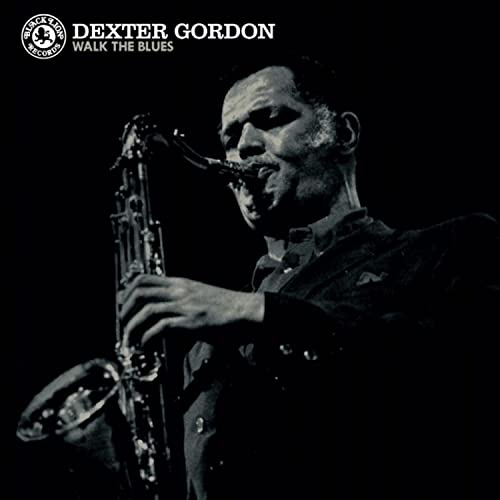 Black and white portrait of Dexter Gordon playing a saxophone.