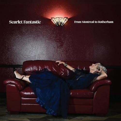 Album cover: woman reclining on a red sofa against a red wall.