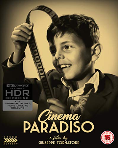 Sepia-toned image of a young boy holding a strip of film to his head.