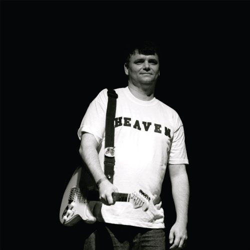 Black and white photo of a man playing an electric guitar.