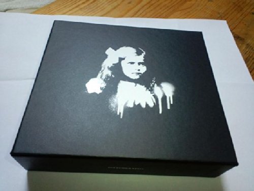 Black box set with a distressed white portrait of a young girl.