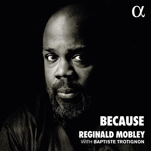 Black and white portrait of Reginald Mobley with album title "Because".