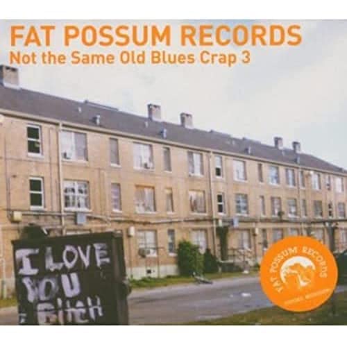 CD cover with a building, graffiti, and orange record label graphic.