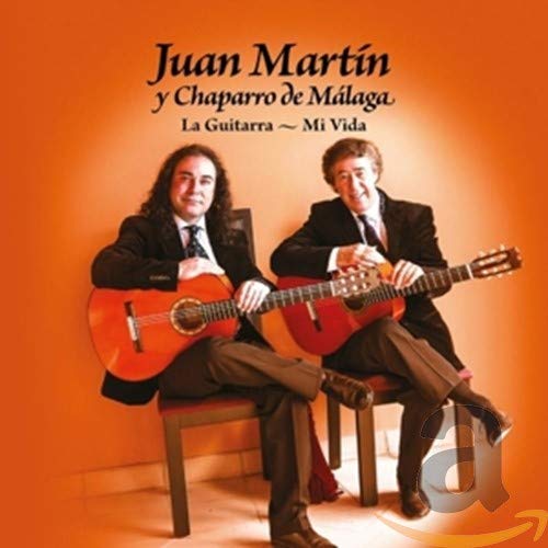 Two men seated, playing classical guitars against an orange background.