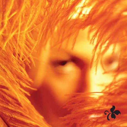 Orange and red abstract album cover with a blurred face and logo.