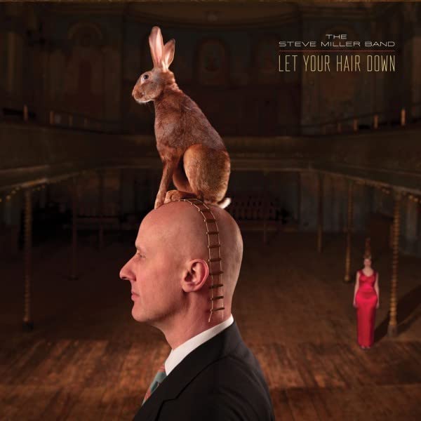 Album cover: man with rabbit on head, stage backdrop, red dress.