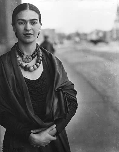 Black and white portrait of Frida Kahlo with beaded necklace and shawl.