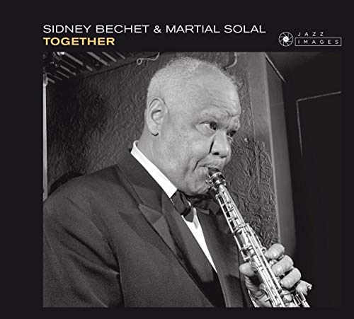 Sidney Bechet playing a clarinet, black and white portrait.