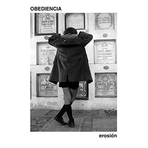 Black and white album cover with a person facing a cemetery wall.