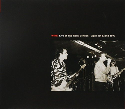 Black and white photo of Wire performing live at The Roxy, London, 1977.