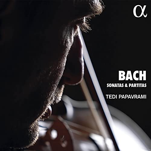 Close-up of violinist Tedi Papavrami with violin, album cover for Bach sonatas.